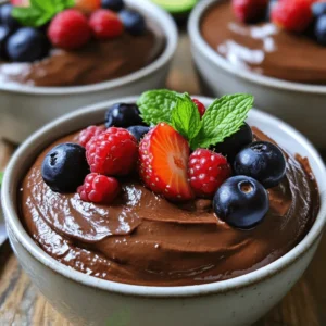 - Avocados: You need 2 ripe avocados. They should be soft and easy to mash. - Cocoa Powder: Use 1/2 cup of unsweetened cocoa powder for rich chocolate flavor. - Sweeteners and Liquids: Add 1/4 cup of maple syrup and 1/4 cup of almond milk. These make the mousse sweet and creamy. - Vanilla and Seasoning: A teaspoon of vanilla extract adds warmth. A pinch of sea salt enhances all the flavors. - Garnishes: Fresh berries and mint leaves are fun toppings. They add color and a fresh taste. Each ingredient plays a key role. The avocados give creaminess, while cocoa adds depth. Sweeteners balance the rich cocoa, and vanilla adds warmth. Together, these ingredients create a delightful chocolate experience. To make this chocolate avocado mousse, you will need a food processor or a blender. First, gather all your ingredients: - 2 ripe avocados, peeled and pitted - 1/2 cup unsweetened cocoa powder - 1/4 cup maple syrup - 1/4 cup almond milk (or any non-dairy milk) - 1 teaspoon vanilla extract - Pinch of sea salt Start by placing the avocados in your food processor. Next, add the cocoa powder, maple syrup, almond milk, vanilla extract, and sea salt. Blend all these ingredients on high speed. Scrape down the sides as needed. This process should take about 2 to 3 minutes. Keep blending until the mixture is smooth and creamy. After blending, taste the mousse. If you want it sweeter, you can add more maple syrup. Blend again for a few seconds if you do. Adjust the sweetness to your liking because everyone has different taste buds. Once your mousse is ready, you can spoon it into individual serving dishes or bowls. Use a nice-sized spoon to fill each dish evenly. This recipe serves four, so each person gets a nice portion. Next, chill the mousse in the refrigerator for at least 30 minutes. This chill time helps the mousse firm up and enhances those rich chocolate flavors. Plus, it tastes even better when cold! Serve it chilled, and if you want to make it look fancy, add fresh berries and mint leaves on top. They will add color and a fresh taste to your dessert. Enjoy your rich and creamy chocolate avocado mousse! - Ideal avocado ripeness: Choose avocados that are ripe but not overripe. They should feel soft when you gently squeeze them. If they are too firm, the mousse won't be creamy. If they are too mushy, it might taste off. - Blending tips: Use a strong blender or food processor for best results. Start blending on low speed. Gradually increase it to high. This helps mix everything well. Scrape the sides of the bowl often. This ensures all ingredients blend smoothly. If the mousse is too thick, you can add a little almond milk. Just a tablespoon at a time until you reach the right creaminess. - Garnishing options: Fresh berries and mint leaves add color and taste. Place a few berries on top. Add a sprig of mint for a nice touch. You can also sprinkle some cocoa powder for a chocolatey look. - Serving suggestions: Serve the mousse in small bowls or glasses. This gives each person their own treat. Chill them before serving. It makes the mousse even more refreshing. You can also layer it in a glass with berries for a fun twist. This adds texture and looks great! {{image_2}} You can change the flavor of your chocolate avocado mousse easily. Here are some fun ways: - Other sweeteners: Instead of maple syrup, try honey or agave nectar. Both give a nice sweetness. You can also use stevia or coconut sugar for a low-calorie option. - Adding spices or extracts: A pinch of cinnamon or nutmeg can add warmth to your mousse. You can also try a splash of mint or orange extract for a fresh twist. These small changes can make your mousse unique each time you serve it. If you have dietary needs, this mousse can fit right in. Here are some ideas: - Dairy-free options: Use almond milk, coconut milk, or oat milk instead of regular milk. This keeps the mousse creamy without dairy. - Nut-free substitutes: If you need nut-free options, just swap almond milk for rice milk or soy milk. This keeps it safe for those with nut allergies. These simple swaps allow everyone to enjoy this rich treat. Store your chocolate avocado mousse in the fridge. Use airtight containers to keep it fresh. If you have leftovers, cover them well to avoid drying out. You can also use plastic wrap directly on the mousse. This helps keep it smooth and creamy. In the fridge, this mousse lasts for about 3 days. After that, the texture may change. You might notice the mousse becomes less creamy. If you see any brown spots, it's best to toss it. Enjoy this rich treat while it's fresh! Can I use ripe bananas instead of avocados? You can use ripe bananas, but it will change the taste. Bananas add a fruity flavor. This mousse will be sweeter and less creamy. If you want to keep that rich texture, stick with avocados. Is this recipe vegan-friendly? Yes, this recipe is vegan! It uses no animal products. The creamy texture comes from avocados, making it a great choice for plant-based diets. You can enjoy this mousse guilt-free. How can I make it sweeter without adding sugar? You can use more maple syrup for sweetness. Try adding a bit of agave syrup too. You can also blend in some dates for a natural sweet flavor. Taste as you go to get it just right. This blog covers a simple recipe for creamy avocado mousse. You learned about key ingredients like avocados and cocoa powder. I shared step-by-step instructions for preparation and serving. The tips and tricks section offered ways to enhance creaminess and presentation. You can adapt the recipe for different diets or flavors. Storing options ensure your mousse stays fresh. Remember, getting creative with your ingredients makes the dish your own. Enjoy making this tasty treat!