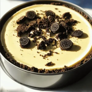 To make a No Bake Oreo Cheesecake, you will need the following ingredients: - 24 Oreo cookies, crushed - 4 tablespoons unsalted butter, melted - 16 oz cream cheese, softened - 1 cup powdered sugar - 1 teaspoon vanilla extract - 1 cup heavy whipping cream - 12 Oreo cookies, roughly chopped for filling - 6 Oreo cookies, crushed for topping - Optional: Chocolate shavings for garnish These ingredients combine to create a rich and creamy dessert. The Oreos give a great flavor and crunch. Using unsalted butter helps control the saltiness. Cream cheese adds a smooth texture, while powdered sugar sweetens the mix. Vanilla extract enhances the cheesecake's flavor. Heavy whipping cream makes it light and fluffy. Chopped Oreos throughout the filling add more cookie goodness. Crushed Oreos on top provide a nice finish. If you want to get fancy, add chocolate shavings for garnish. To make the crust, start by crushing 24 Oreo cookies. You can use a food processor or place them in a bag and crush them with a rolling pin. Next, melt 4 tablespoons of unsalted butter. Mix the crushed cookies with the melted butter until it looks like wet sand. This mixture is key to a tasty crust. Now, take a 9-inch springform pan. Press the Oreo mixture into the bottom of the pan. Use the back of a measuring cup to pack it tightly. This helps the crust hold together. Once you finish, put the pan in the fridge while you make the filling. Chilling it will keep the crust firm. In a large bowl, beat 16 ounces of softened cream cheese. Use an electric mixer set to medium speed. Mix until it is smooth and creamy. This step is important for a rich filling. Then, slowly add in 1 cup of powdered sugar and 1 teaspoon of vanilla extract. Continue mixing until everything is well combined. In a separate bowl, whip 1 cup of heavy cream on high speed. Whip until stiff peaks form. This means when you lift the beaters, the cream holds its shape. Gently fold the whipped cream into the cream cheese mixture. Be careful not to deflate the whipped cream. This keeps the filling light and fluffy. Finally, stir in 12 roughly chopped Oreo cookies. They add a nice texture to the filling. Take the crust out of the fridge. Pour the filling over the chilled crust. Spread it evenly across the surface. Tap the springform pan on the counter a few times. This helps remove any air bubbles. For a final touch, sprinkle 6 crushed Oreo cookies on top of the cheesecake. This adds a delicious decoration. Cover the cheesecake with plastic wrap. Refrigerate it for at least 4 hours, or overnight if you can wait. This allows the cheesecake to set properly. After it's firm, carefully remove the sides of the springform pan. If you want, add chocolate shavings as a garnish. Enjoy your no-bake Oreo cheesecake! To get the best texture for your No Bake Oreo Cheesecake, use cream cheese at room temperature. Cold cream cheese can make lumps in your filling. Softened cream cheese mixes in smoothly. This gives your cheesecake a creamy base. Folding is key to making your filling light and airy. After you whip the cream, gently fold it into the cream cheese mix. Use a spatula and move in a circular motion. Be careful not to stir too hard. You want to keep the air in the whipped cream. For toppings, sprinkle crushed Oreo cookies on top. You can also add chocolate shavings for extra flair. These toppings not only look good but also add more flavor. Pair your cheesecake with a glass of cold milk or a cup of coffee. The rich flavors of the cheesecake work well with these drinks. If you want something sweet, serve it with chocolate ice cream. This makes a great dessert combo that everyone will love. {{image_2}} You can easily change the flavor of your No Bake Oreo Cheesecake. One fun way is to use different cookies. For example, try using Golden Oreos instead of regular ones. This will give your cheesecake a sweeter and lighter taste. You can also add mint extract to the filling. Just a teaspoon will make your dessert fresh and cool. If you want a richer flavor, consider adding a bit of espresso powder. This enhances the chocolate taste of the Oreos. You can adjust the recipe to fit any gathering size. If you have a small group, you can cut the recipe in half. This way, you still enjoy this treat without leftovers. For larger gatherings, simply double the ingredients. This will ensure everyone gets a slice. Another fun idea is to make mini cheesecakes. Use a muffin tin or small cups. Just layer the crust and filling in each cup. This makes perfect individual servings. Plus, they are easy to share and even easier to eat! To keep your No Bake Oreo Cheesecake fresh, wrap it well. Use plastic wrap to cover the cheesecake. This helps prevent it from drying out. You can also use an airtight container. When stored correctly, it lasts up to five days in the refrigerator. Always place it on a flat surface to avoid bumps. If you have leftovers, you can freeze them. Cut the cheesecake into slices first. Wrap each slice in plastic wrap, then place them in a freezer-safe bag. This way, you can enjoy a piece later. To thaw, remove a slice from the freezer and place it in the fridge overnight. This keeps the texture nice and creamy. Enjoy your cheesecake at its best! Yes, you can use light cream cheese in this recipe. However, it may change the taste and texture. Light cream cheese is less rich and creamy. Your cheesecake might be less thick and not as silky. If you want a lighter option, this can work. Just keep in mind the taste may be different. The cheesecake needs to set for at least 4 hours. This time helps it firm up nicely. For the best results, I suggest chilling it overnight. This way, all the flavors blend together well. The longer it chills, the better it tastes! Yes, you can make this cheesecake gluten-free! Look for gluten-free Oreo cookies. There are brands that offer these options. You can also use gluten-free chocolate sandwich cookies. They work just as well in the crust and filling. Enjoy a delicious treat without the gluten! This blog post covered how to make a delicious cheesecake. We went through the ingredients, step-by-step instructions, and tips to get the texture just right. You can even modify the recipe for different flavors or serving sizes. Storing your cheesecake properly ensures it stays fresh. Remember to check the FAQs for common questions and answers. By following these steps, you'll create a cheesecake everyone will love. Enjoy experimenting and sharing your tasty treats!